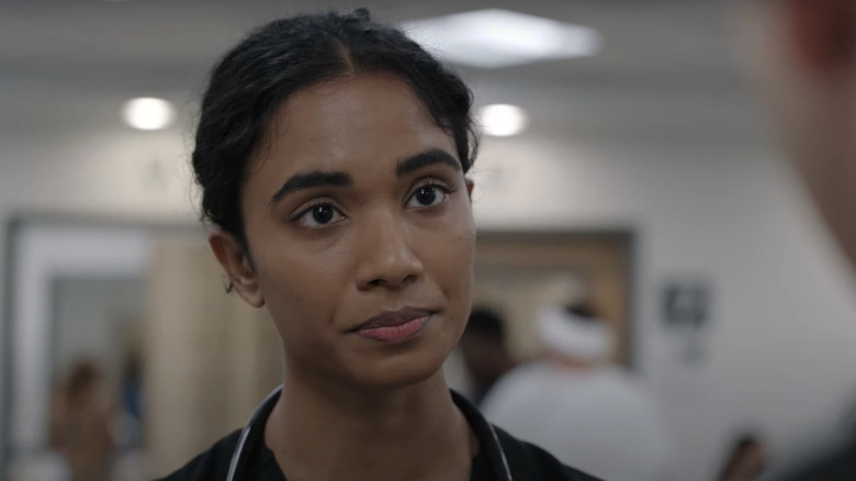 Supriya Ganesh's Dr. Samira Mohan looks across frame in The Pitt