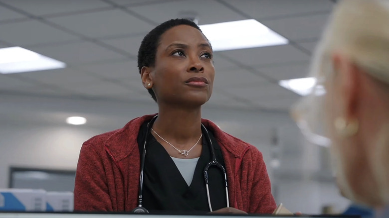 Tracy Ifeachor's Dr. Heather Collins looks up while standing in the ER in The Pitt