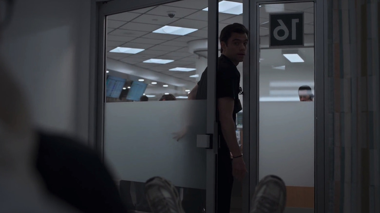 Patrick Ball's Frank Langdon stands in the doorway of a darkened treatment room in The Pitt