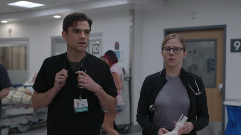 Patrick Ball's Frank Langdon walks alongside Taylor Dearden's Mel King through the ER in The Pitt