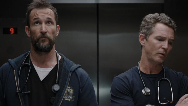 Noah Wyle's Dr Michael Robinavitch stands in an elevator next to Shawn Hatosy's Dr. Jack Abbot in The Pitt