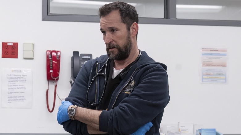Robby with his arms crossed looking at someone on The Pitt
