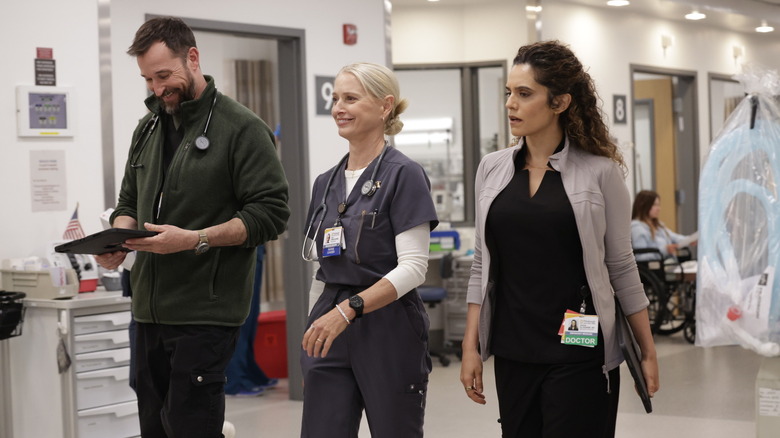 Robby and Dana laughing next to a stressed Baran in the pit on The Pitt