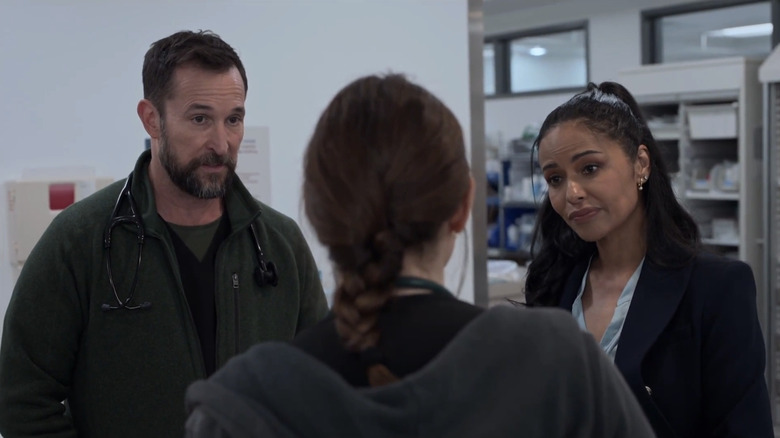 Noah Wyle's Dr Michael Robinavitch stands alongside Meta Golding's Noelle Hastings as they talk to Fiona Dourif's Dr Cassie McKay in The Pitt