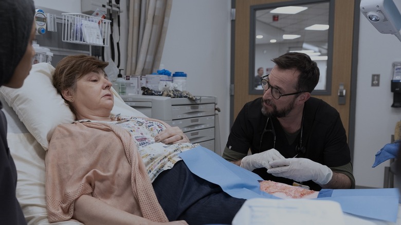 Yana in her bed with Robby treating her on The Pitt