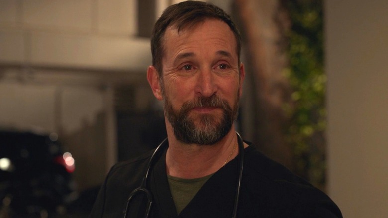 Noah Wyle as Dr. Michael Robinavitch standing in the ambulance bay with tears in his eyes