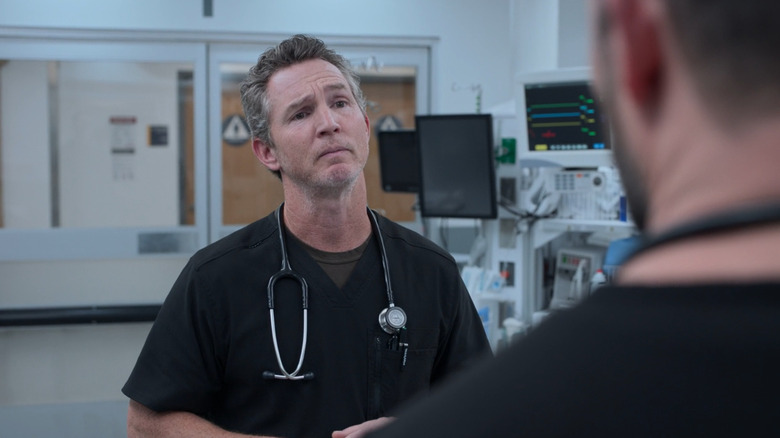 Shawn Hatosy as Dr. Abbott looking at Noah Wyle as Dr. Robinavitch in a trauma room on The Pitt