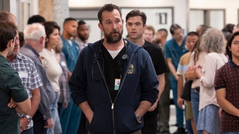Noah Wyle as Dr. Robby in the middle of a crowd on The Pitt