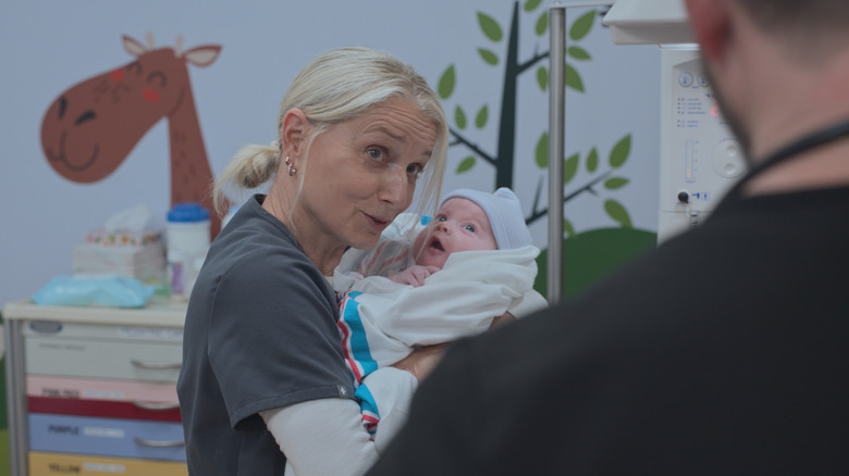 Dana holding Baby Jane Doe in the nursery on The Pitt