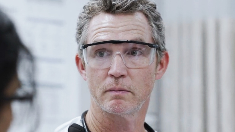 Sean Hatosy as Dr. Abott stands in a surgery room in The Pitt
