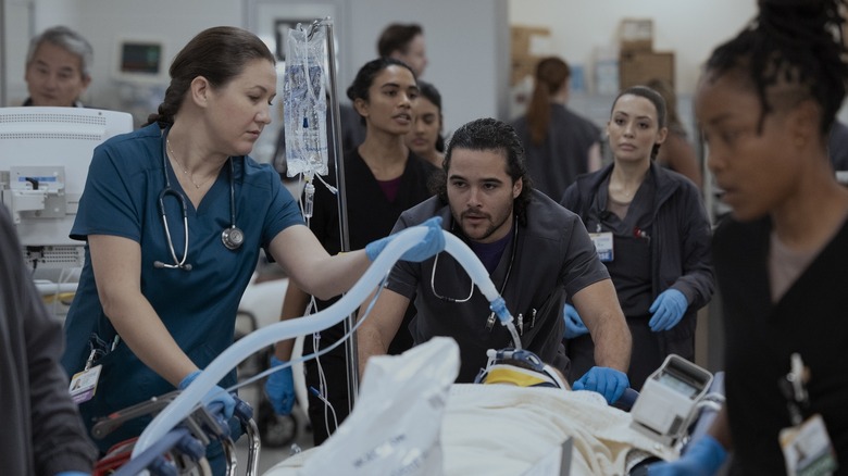 Mateo pushing a patient on a gurney in The Pitt season 2