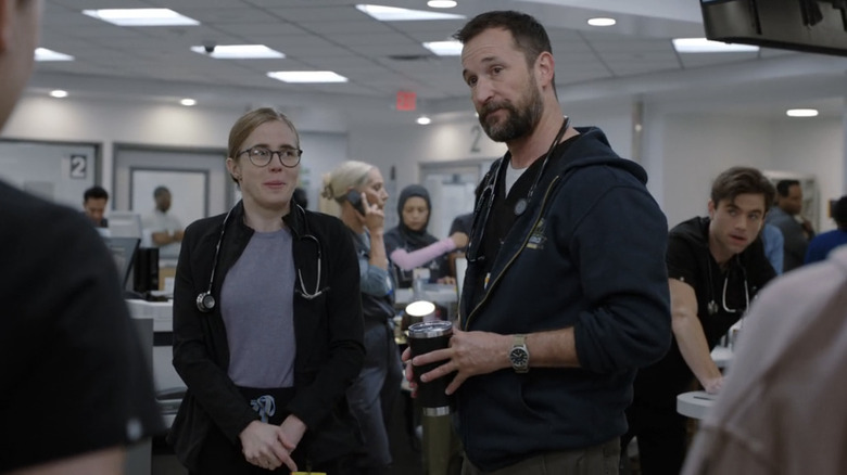 Noah Wyle's Dr Michael Robinavitch stands next to Taylor Dearden's Dr Mel King in The Pitt