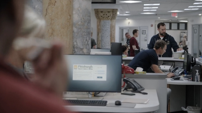 Noah Wyle's Dr Michael Robinavitch looks through files in the ER in The Pitt