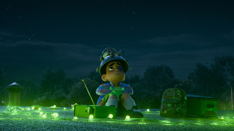 Elio (Yonas Kibreab) looking up at the sky surrounded by lights in Elio