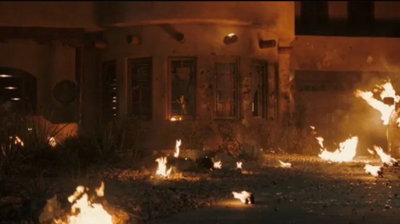 Carol's house burning after a grenade goes off on Pluribus
