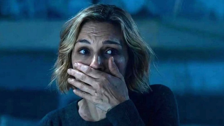 Carol holding her hand over her mouth in horror on Pluribus