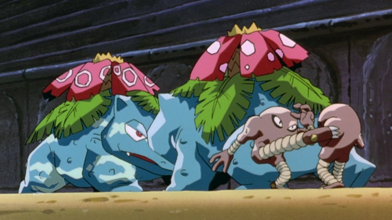 Two sets of Pokémon battling each other in an arena, a scene from Pokémon: The First Movie.