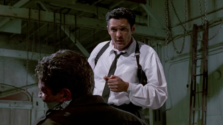 Michael Madsen showing hand dirtied with wet cement