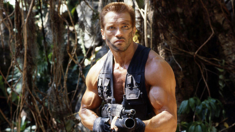 Arnold Schwarzenegger holding a gun in Predator