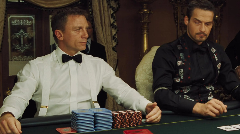 Daniel Craig's James Bond looks to his left as he sits at a poker table in Casino Royale