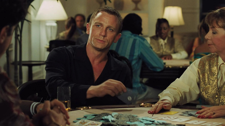 Daniel Craig's James Bond looks across a poker table as he prepares to lay a card in Casino Royale