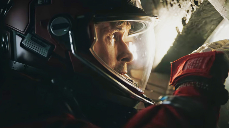 Ryan Gosling's Ryland Grace looks at a bright light while wearing his helmet in Project Hail Mary