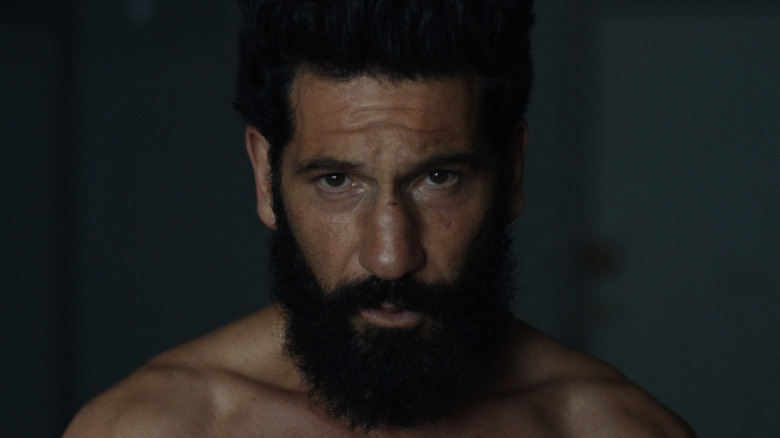Jon Bernthal as Frank Castle sporting a dark beard and staring at the camera in The Punisher: One Last Kill