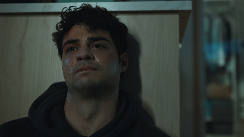 Owen Hendricks leaning against a counter, looking exhausted, in The Recruit