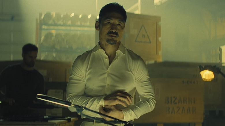 Quinn doing up his cuffs in Reacher season 3