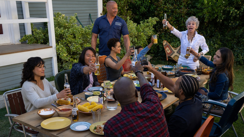 Vin Diesel as Dominic Toretto sharing a toast with Michelle Rodriguez as Letty, Sung Kang as Han, Nathalie Emmanuel as Ramsey, Rita Moreno as Abuelita, and the rest of the cast in Fast X