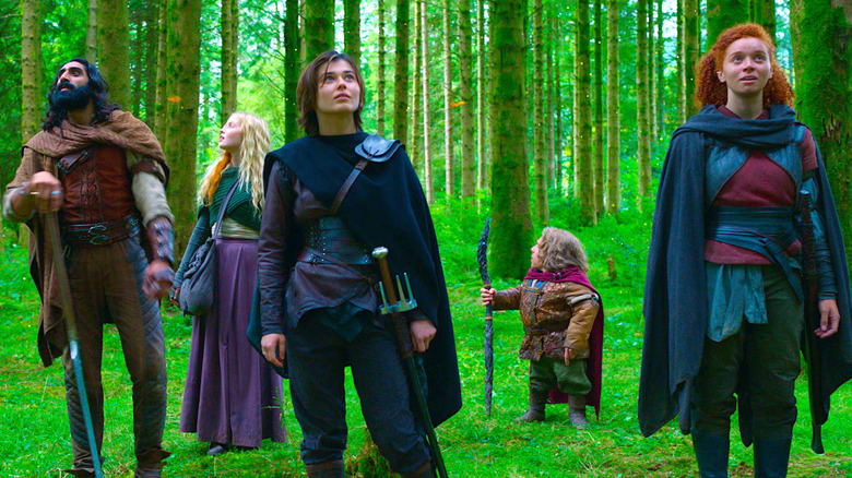 Willow and his compatriots standing awestruck in a very, very green forest