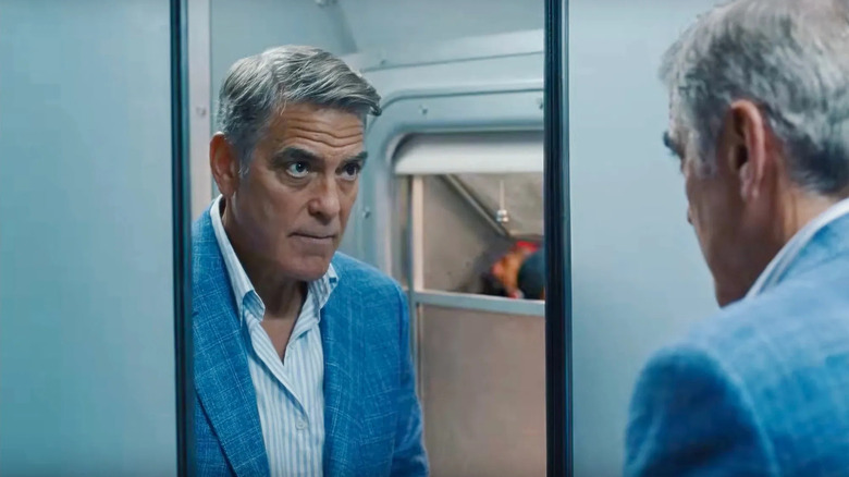 Jay Kelly, looking at himself in a bathroom mirror on a train in Jay Kelly