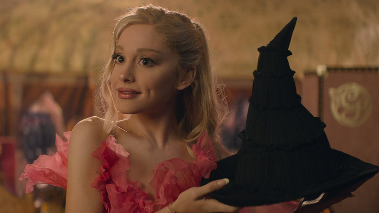 Galinda holding a black hat in Wicked: Part One