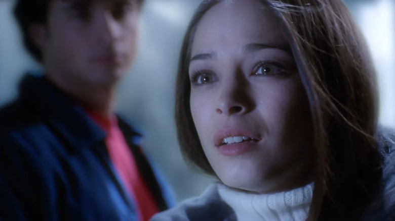 Kristin Kreuk as Lana Lang standing with Tom Welling as Clark Kent in Smallville