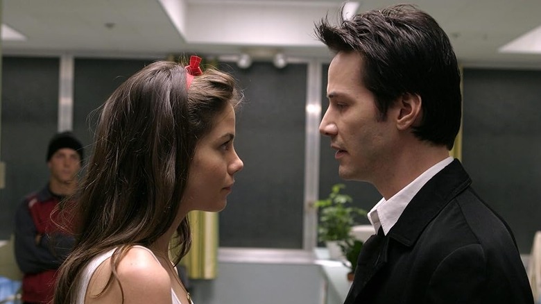 Michelle Monaghan as Ellie standing face to face with Keanu Reeves as John Constantine in Constantine