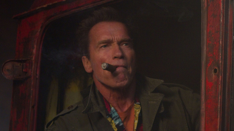 Arnold Schwarzengger smoking a cigar in The Expendables 2