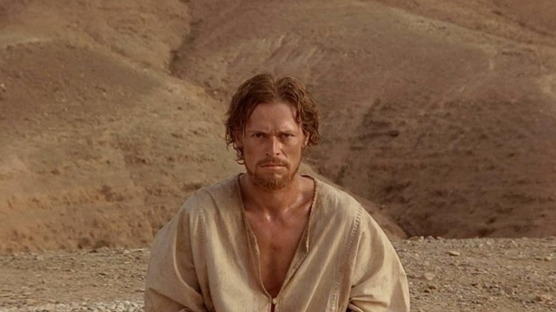 Jesus Christ sitting in the desert in The Last Temptation of Christ