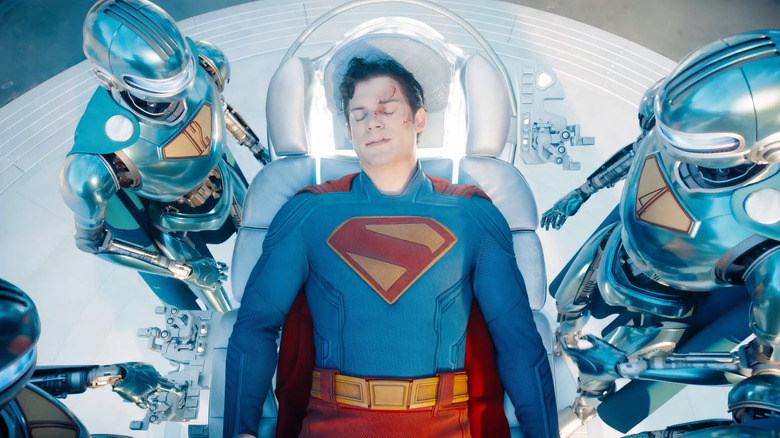 David Corenswet as an injured Superman is attended by his Superman Robots in Superman (2025)