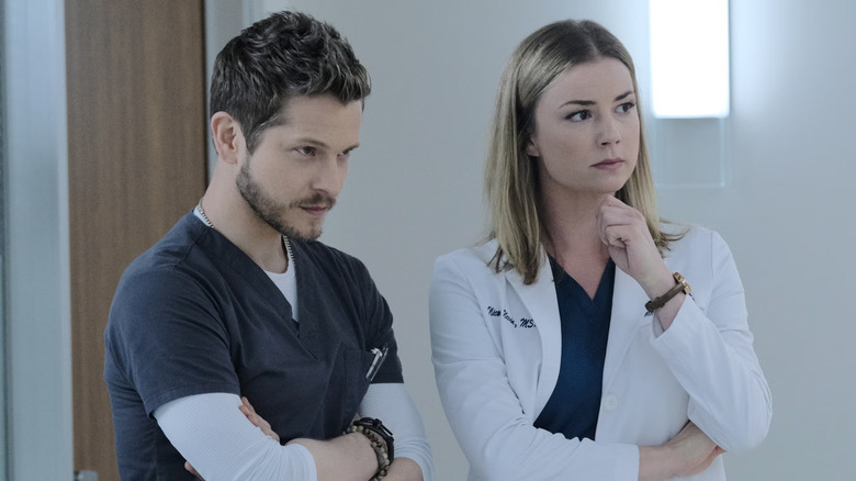 Conrad and Nic listening to someone in a hallway on The Resident