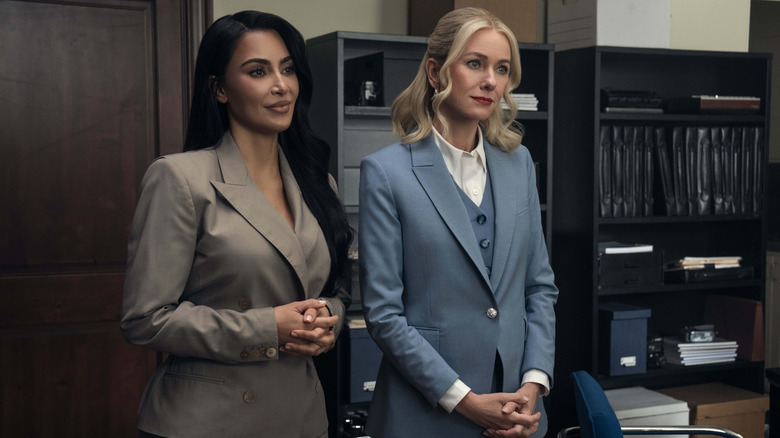 Kim Kardashian as Allura Grant and Naomi Watts as Liberty Ronson standing in an office on All's Fair