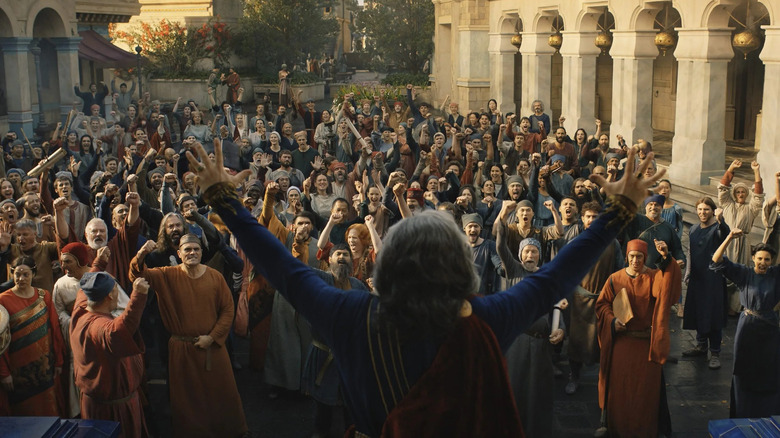A crowd celebrates in The Lord of the Rings: The Rings of Power
