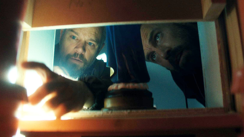 Matt Damon as Dane Dumars and Ben Affleck as JD Byrne investigate a dark space in The Rip