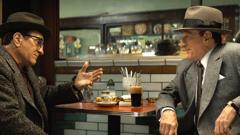 Robert De Niro sits in a diner playing both Frank Costello and Vito Genovese in The Alto Knights