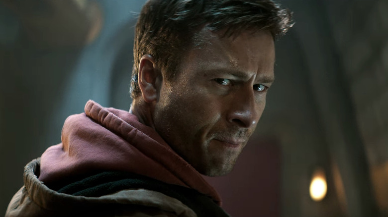 Glen Powell as Ben Richards looking over his shoulder in The Running Man