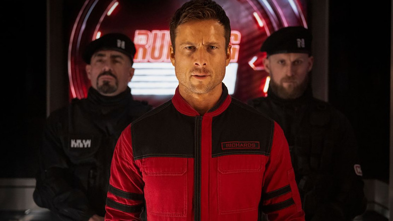 Ben Richards (Glen Powell) is escorted onto the set of The Running Man