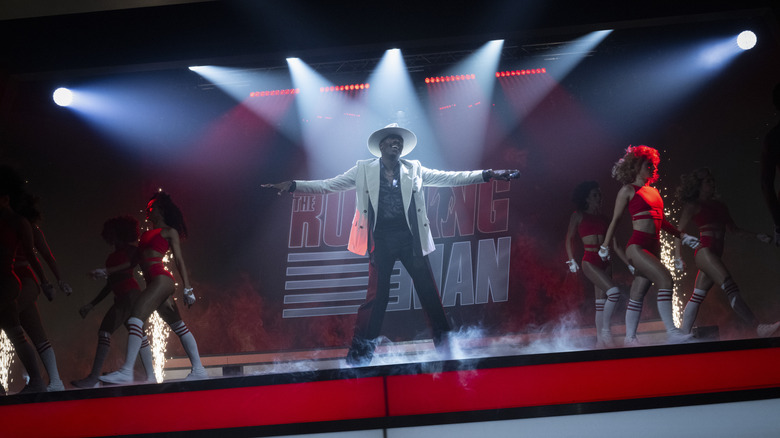 Bobby T. doing a dramatic entrance to the Running Man set as lights flash and the background dancers perform