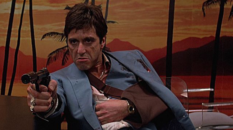 An injured Tony Montana holding a gun