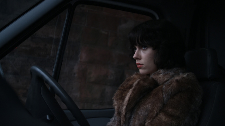 Scarlett Johansson's the Female sits in a van looking out the windshield in Under the Skin