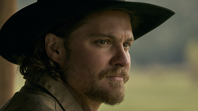 Luke Grimes's Kayce Dutton looks off into the distance in Yellowstone
