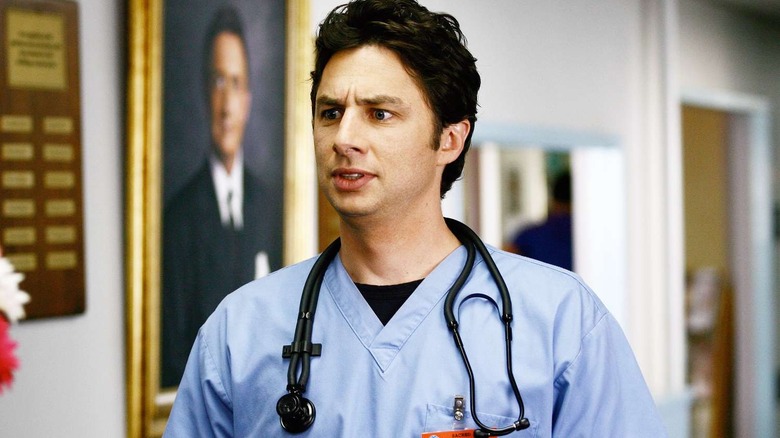 JD looking concerned in the hallway wearing his stethoscope on Scrubs